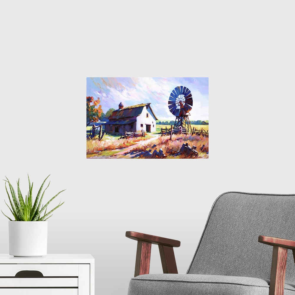 A modern room featuring This impressionistic landscape of a farmhouse and windmill set amidst the golden fields of the co...