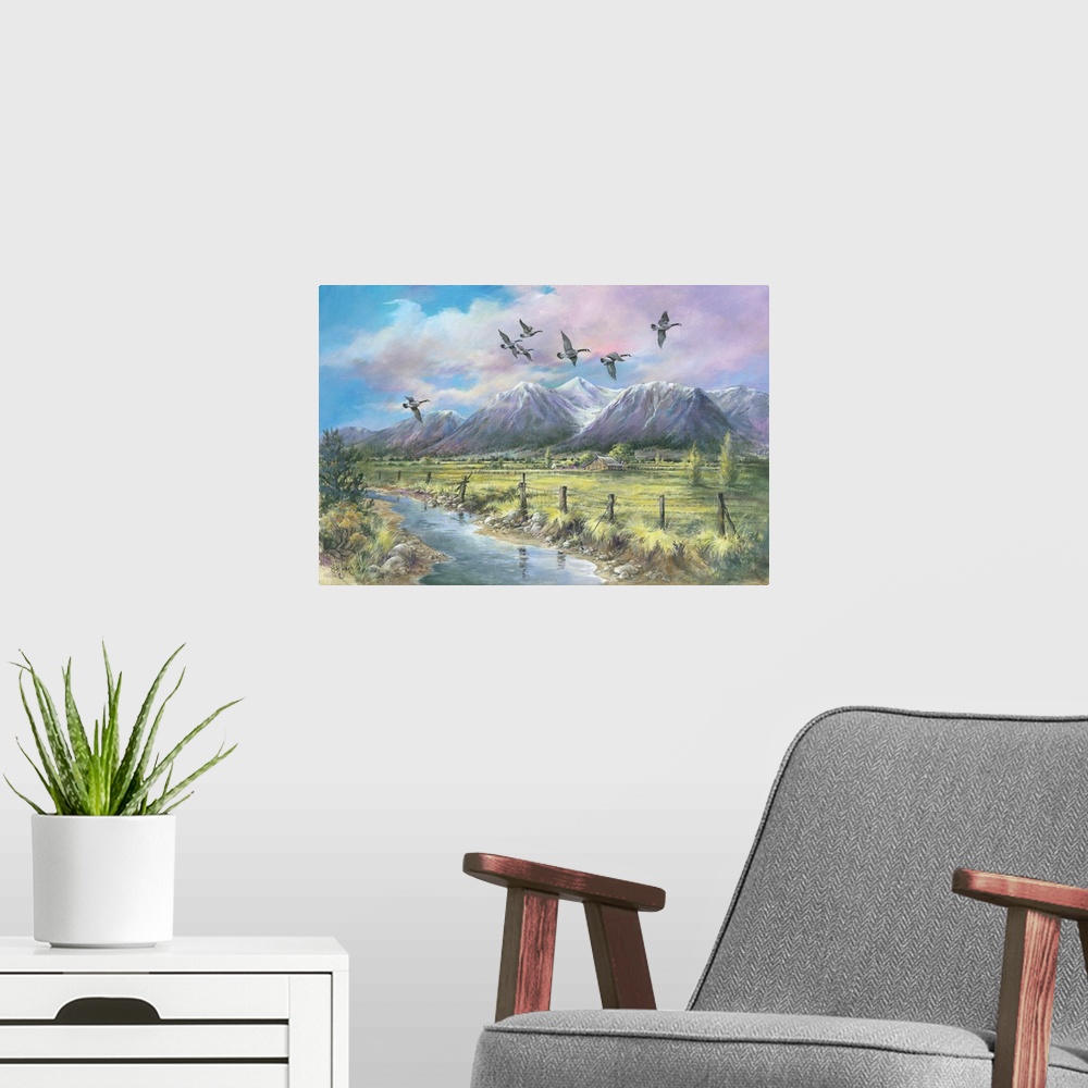 A modern room featuring Contemporary painting a mountainous valley and an old barn in the distance, with geese flying ove...