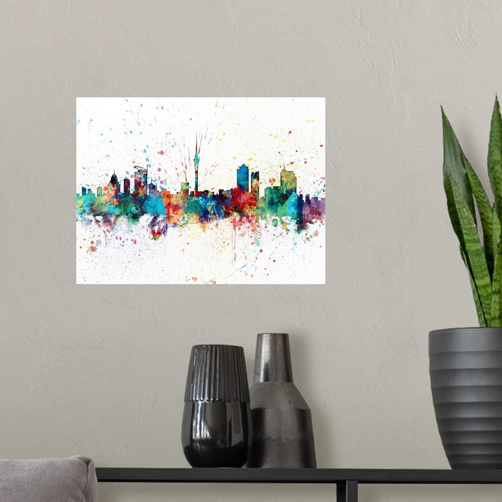 A modern room featuring paint splashes art print of the skyline of Auckland, New Zealand