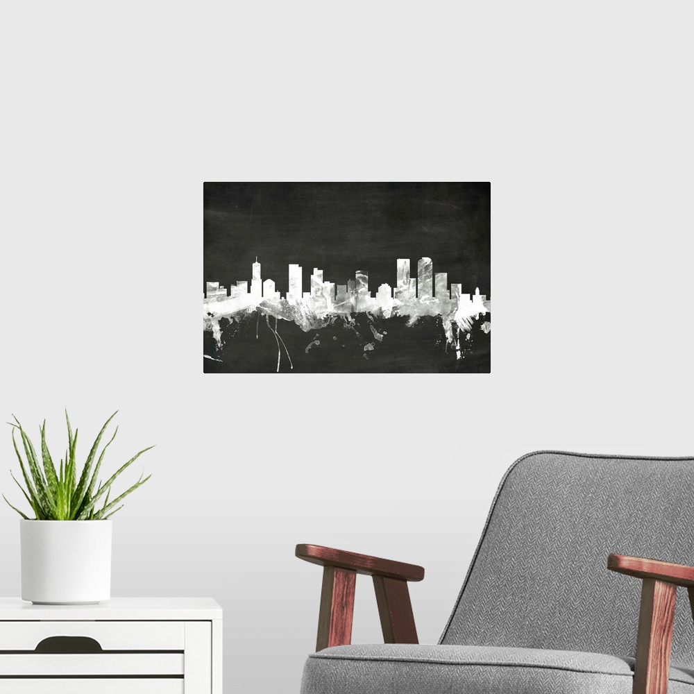 A modern room featuring Smokey dark watercolor silhouette of the Denver city skyline against chalkboard background.