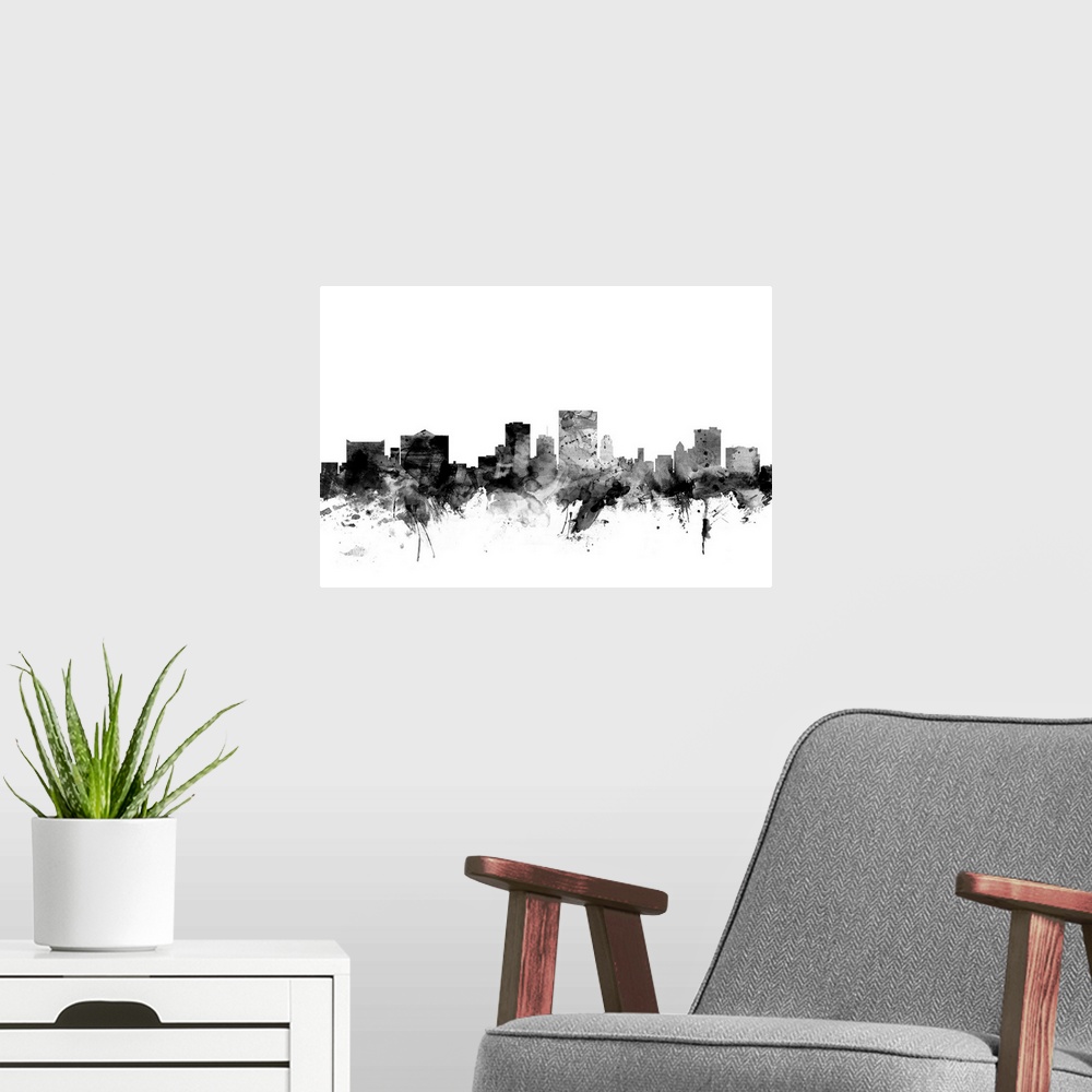 A modern room featuring Contemporary artwork of the El Paso city skyline in black watercolor paint splashes.