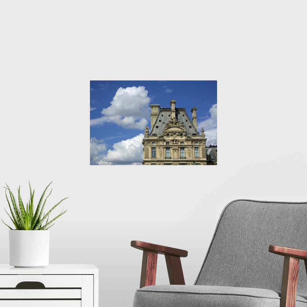 A modern room featuring The Louvre Museum in Paris, France, on a cloudy day