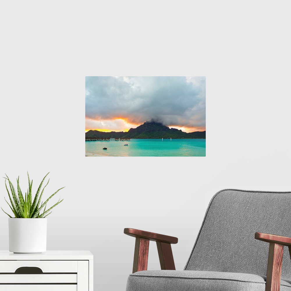 A modern room featuring A cloudy sunset over Mount Otemanu and the Pacific Ocean.