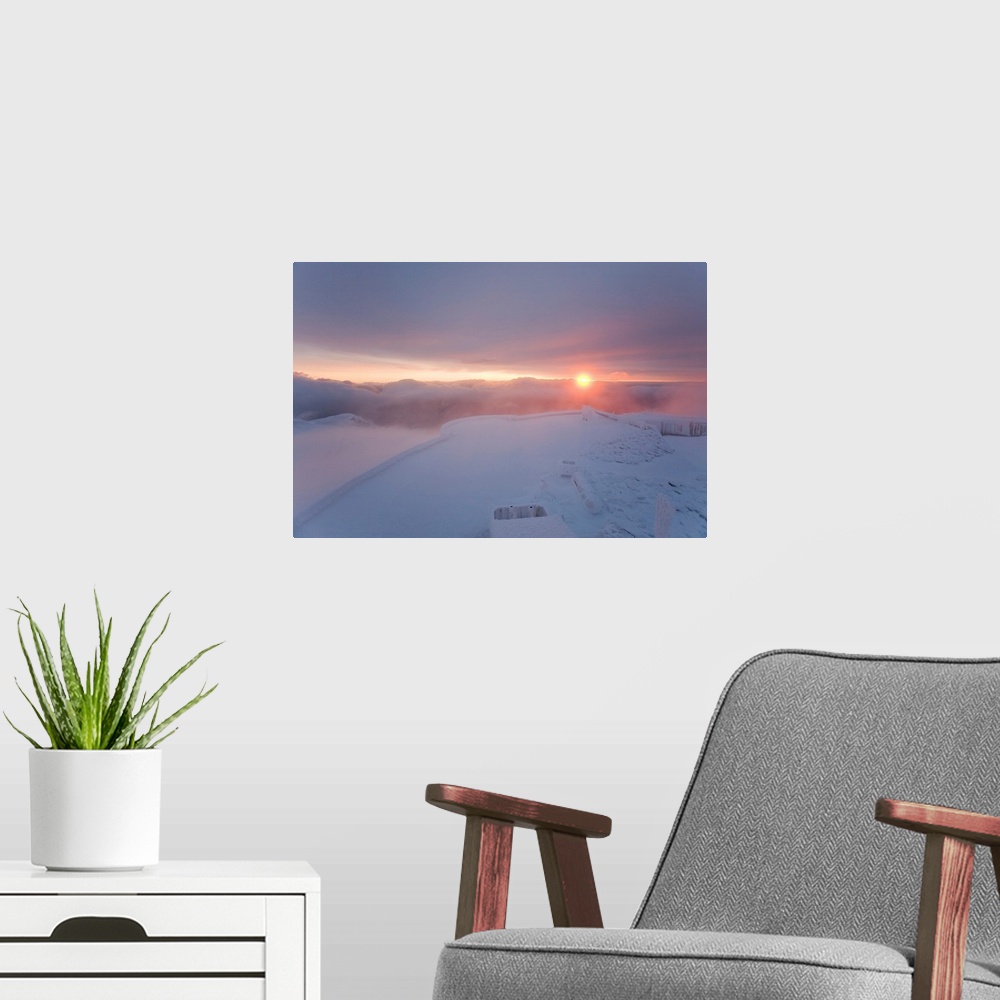 A modern room featuring A colorful sunrise on the summit of Mt. Washington.