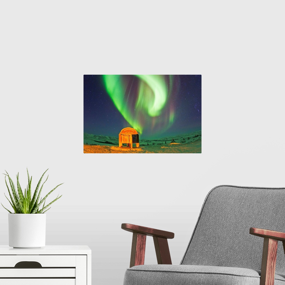 A modern room featuring An aurora borealis near the famous Arctic Circle sign.