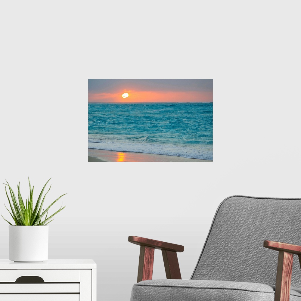 A modern room featuring From the National Geographic Collection, a photo canvas of choppy ocean waves crashing onto a tro...
