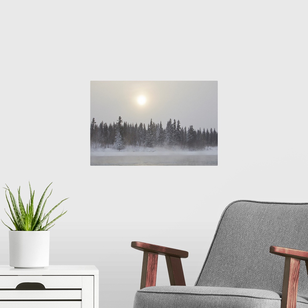 A modern room featuring The sun glowing through thick clouds in subzero temperatures along the Yukon River.