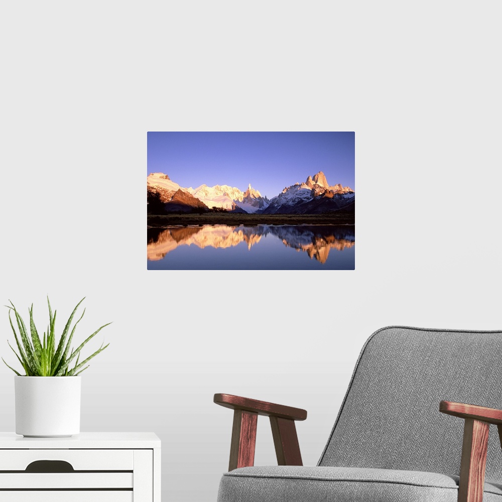 A modern room featuring Cerro Torre, centre, and Mount FitzRoy, right, Cerro Solo, left, at dawn famous peaks on edge of ...