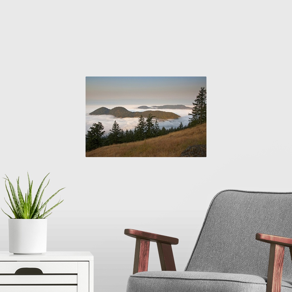 A modern room featuring Entrance Mountain and Mount Woolard emerge from sea fog around Orcas Island as seen from Mt. Cons...