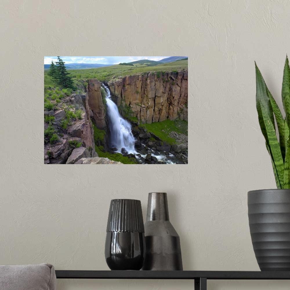 A modern room featuring North Clear Creek Waterfall cascading down cliff, Colorado
