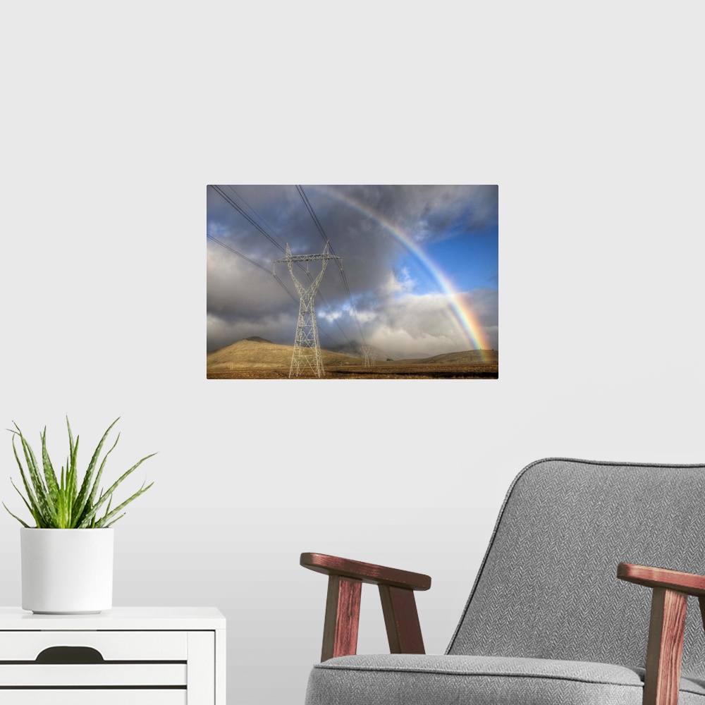 A modern room featuring Powerlines, rainbow forms as evening sun lights up rain clouds, Canterbury, New Zealand