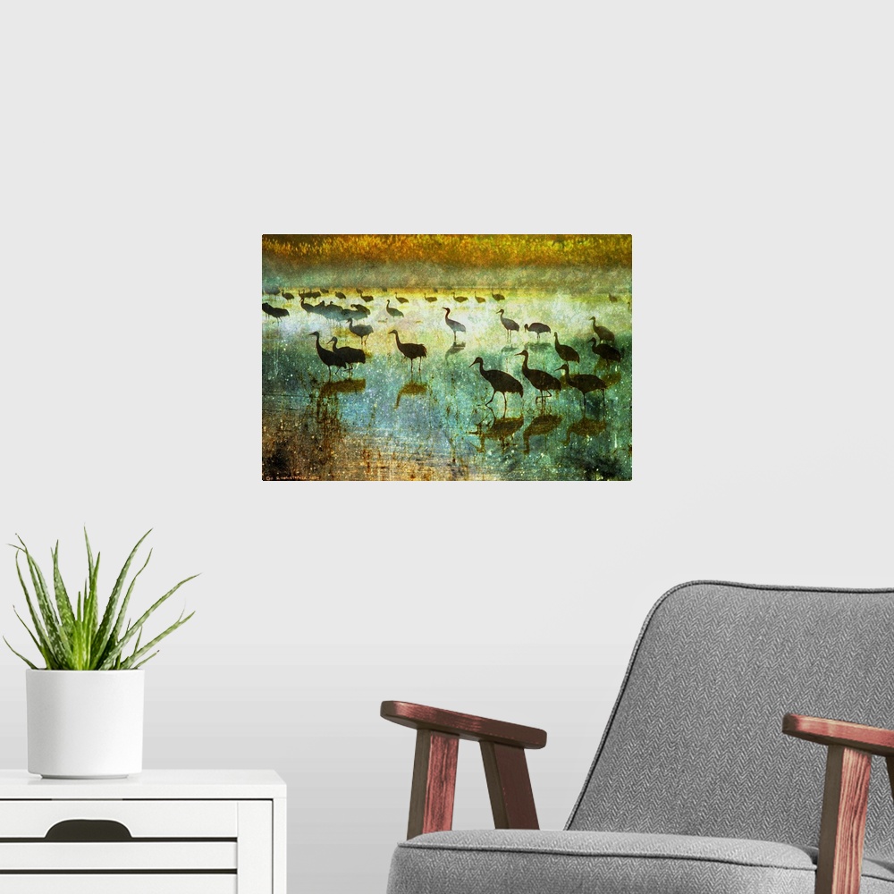 A modern room featuring Contemporary artwork of silhouetted cranes standing in water.