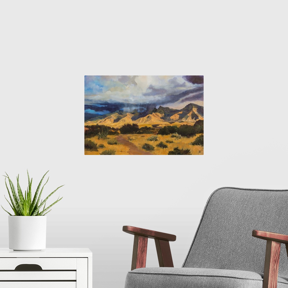 A modern room featuring Contemporary painting of an idyllic desert landscape with dark clouds hovering overhead.