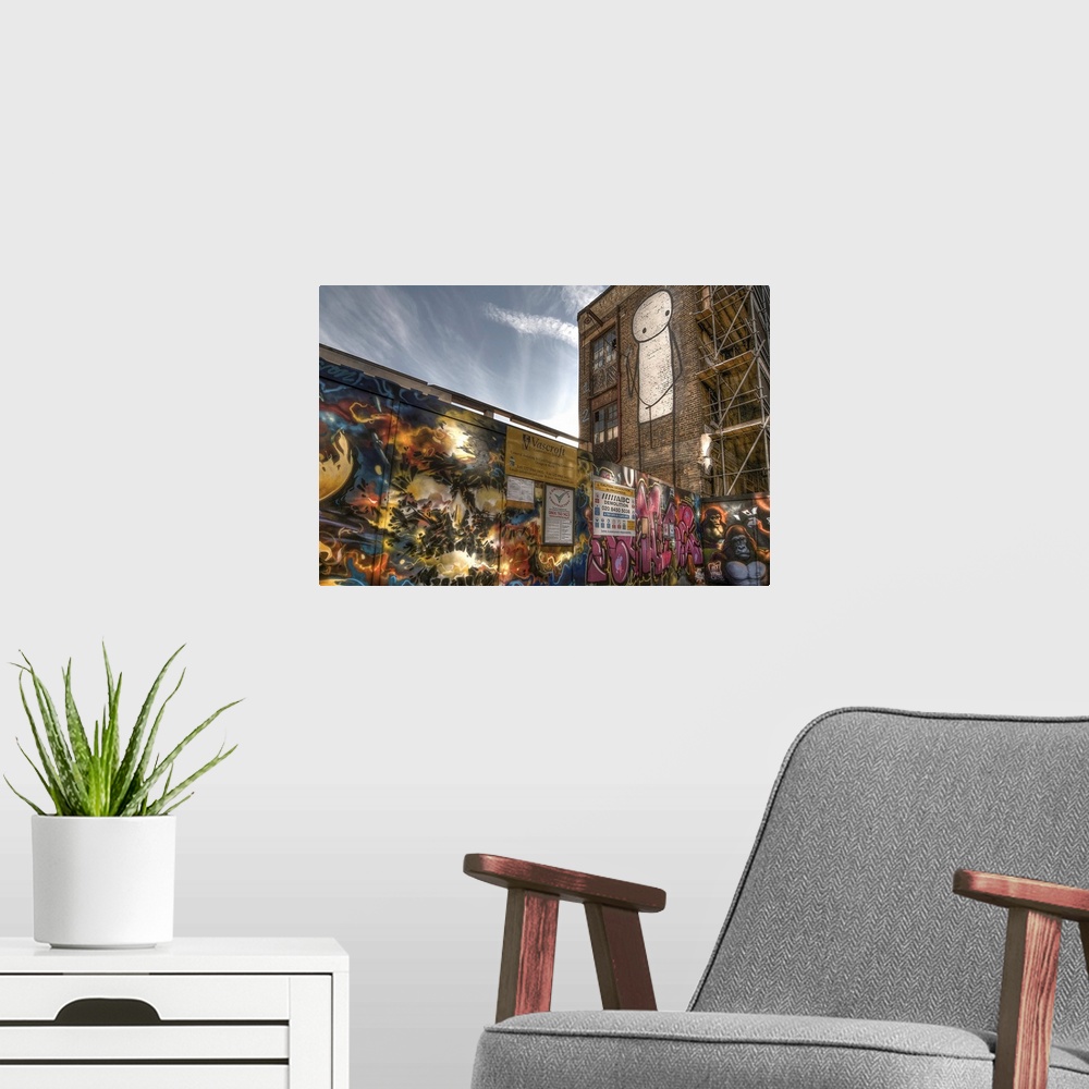 A modern room featuring Fine art photograph of a graffiti on the facade of a city building.