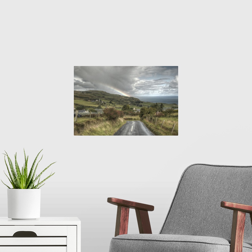 A modern room featuring A photograph looking down the road of a countryside landscape in Northern Ireland.