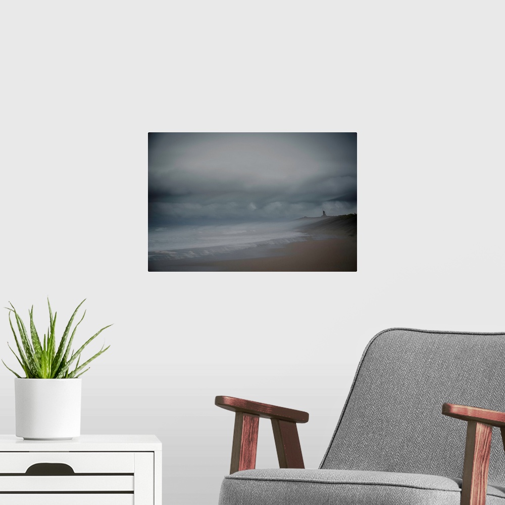 A modern room featuring Landscape photograph of the beach on an overcast day, created with multiple exposures.