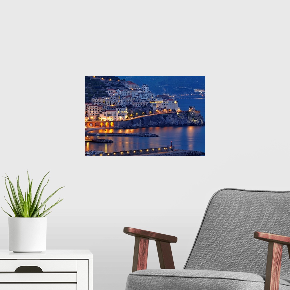 A modern room featuring High angle view of Amalfi Town at night,  Campania, Italy.