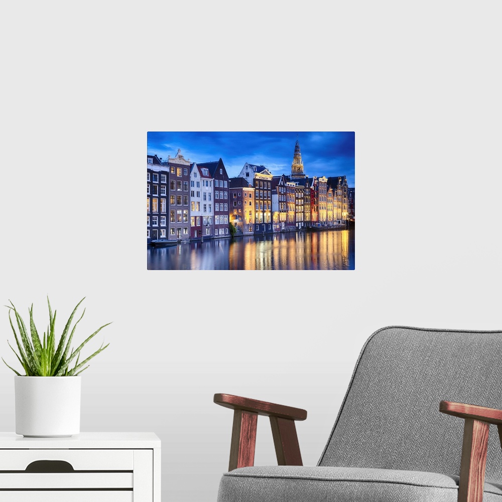 A modern room featuring Amsterdam Illuminated at Dusk with the Oude Church in The Background, North Holland, The Neherklands