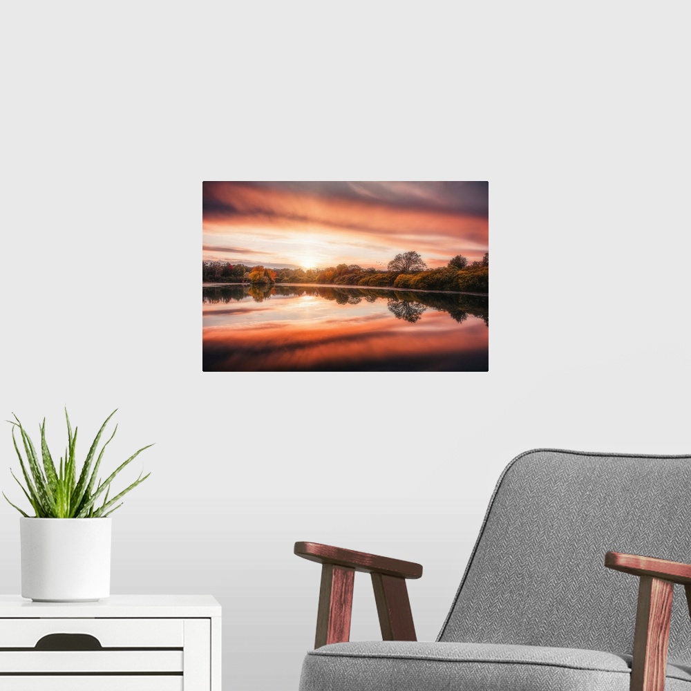 A modern room featuring Sunset over a lake in autumn with a beautiful reflection
