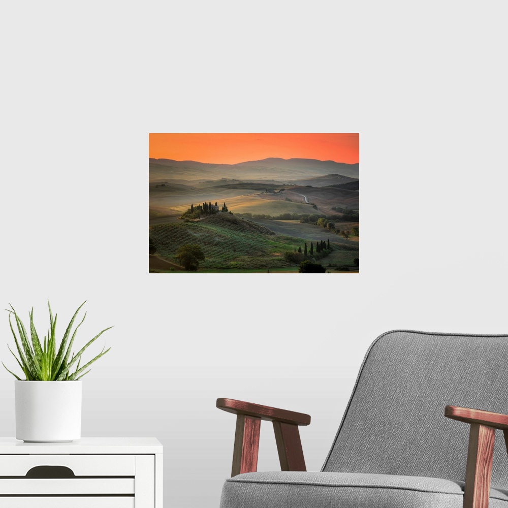 A modern room featuring Sunrise in the rolling hill countryside of Tuscany in Italy.