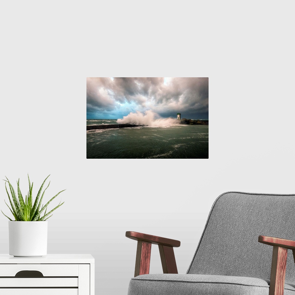 A modern room featuring A photograph of a lighthouse in France being hit with crashing waves.