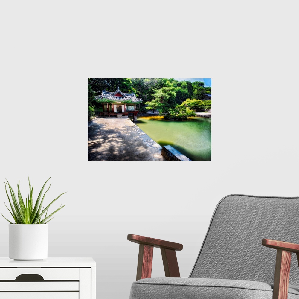 A modern room featuring Fine art photo of a pond and small building in a garden in South Korea.