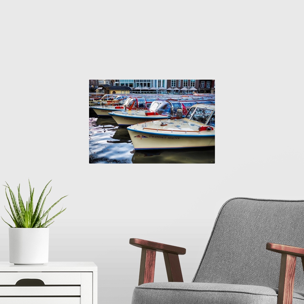 A modern room featuring Classic motorboats lined up in a pier, Amsterdam Netherlands.