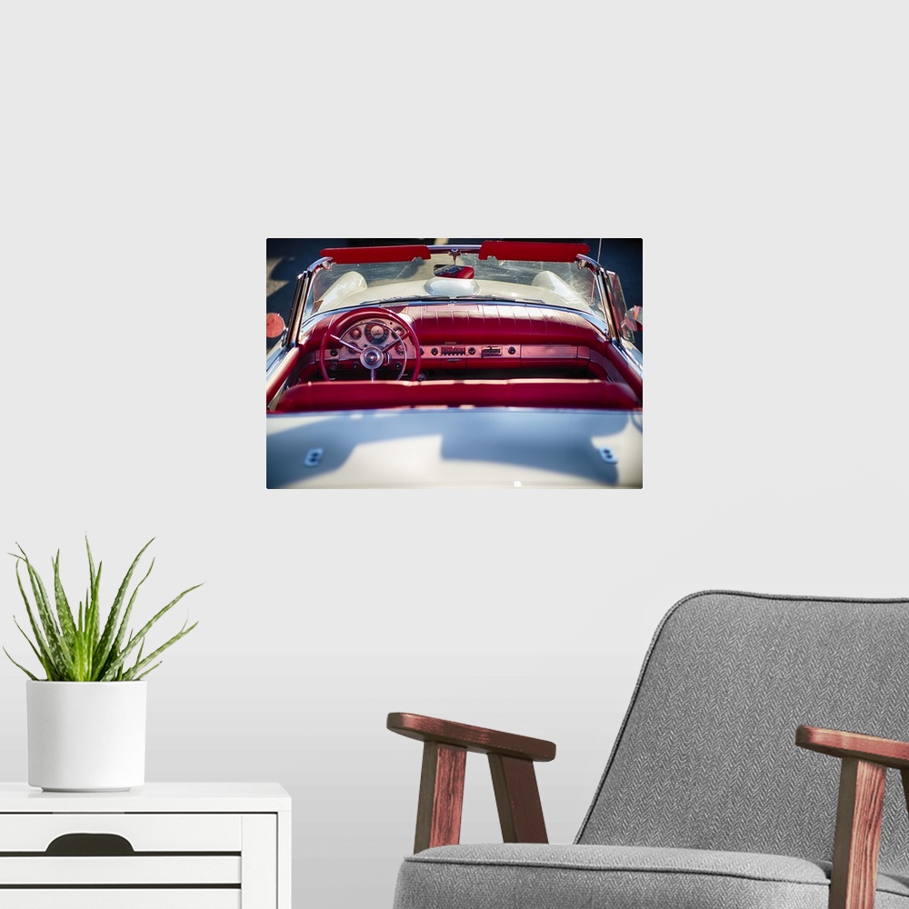 A modern room featuring A photograph of a vintage convertible.