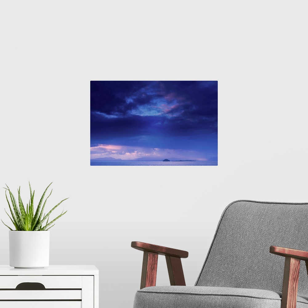A modern room featuring Fine art photo of a deep blue sky with storm clouds over the ocean.