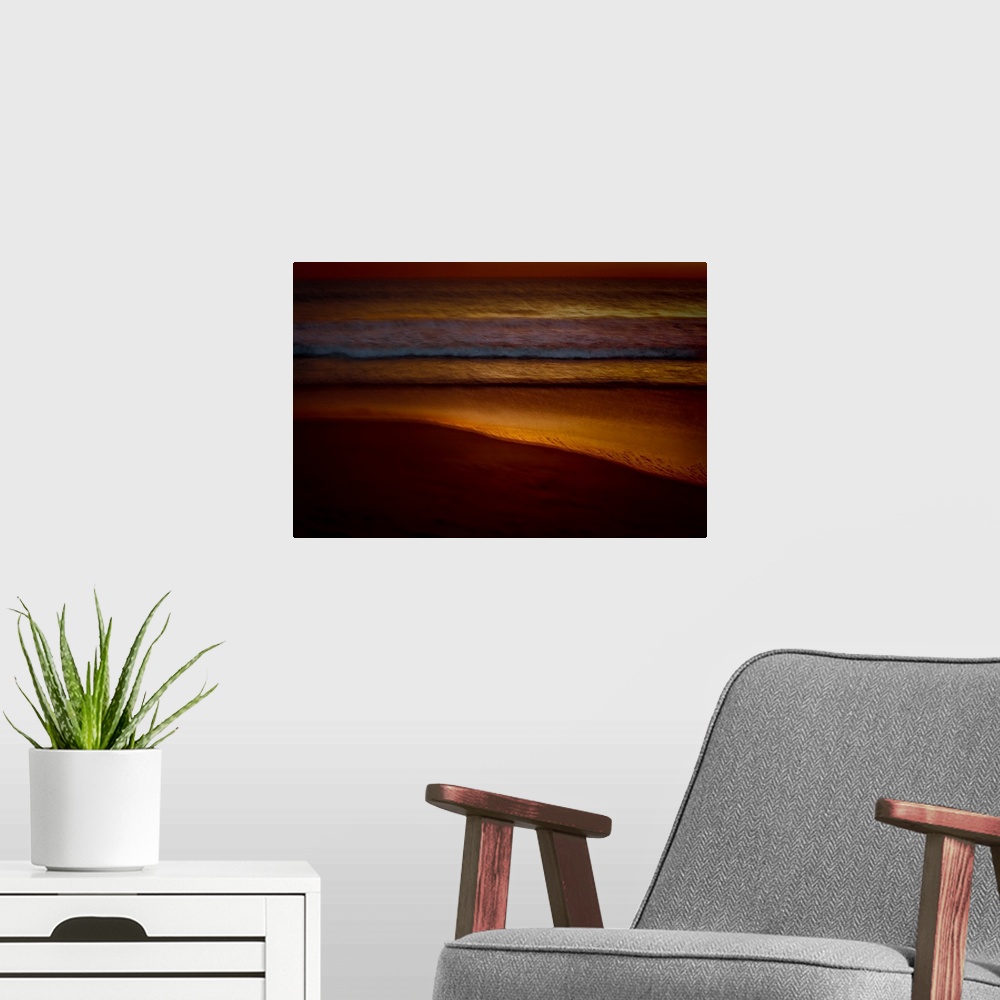 A modern room featuring Golden lit photograph of ocean waves rolling on to the beach shore with a blurred look, created w...