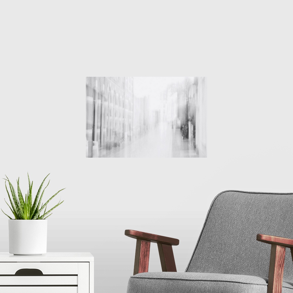 A modern room featuring Artistically blurred photo. Faint memories of the past accompany you when you walk through a stre...