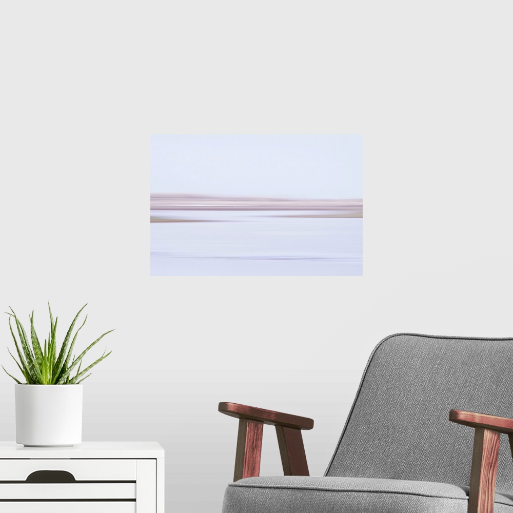 A modern room featuring Artistically blurred photo. The first rays of the rising sun touch the cold water of these marshes.