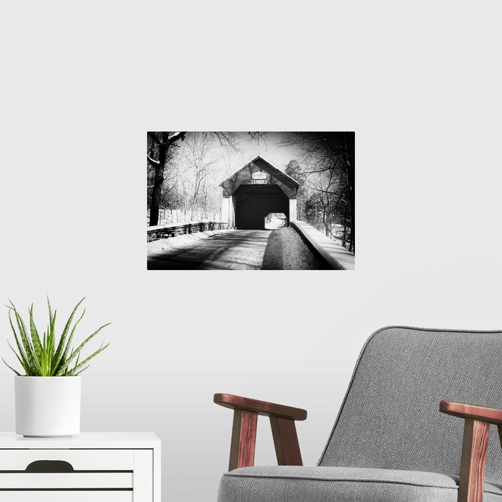 A modern room featuring A black and white image of Frankenfield Covered Bridge in Pennsylvania, with a light snowfall.