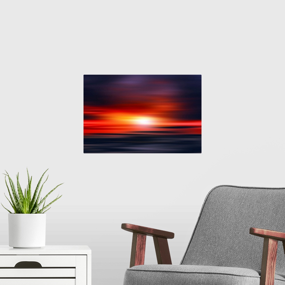 A modern room featuring Abstract photograph of a bright red sunset with contrasting dark purple and blue hues above and b...