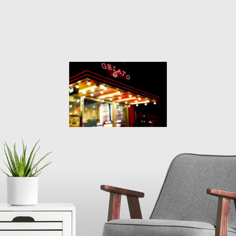A modern room featuring Neon signs of an ice cream parlour illuminating at night.