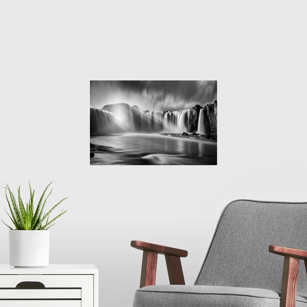 A modern room featuring Fine art photograph of sunlight shining over the waterfalls in Iceland.
