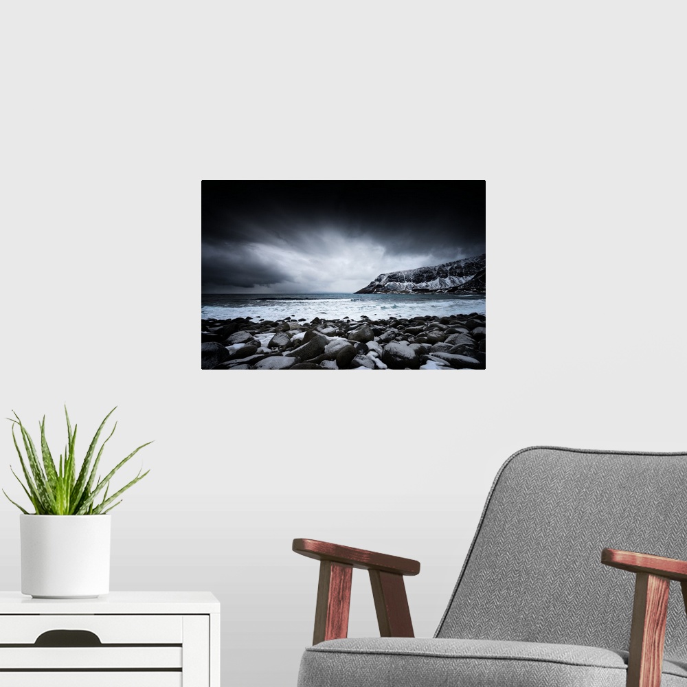A modern room featuring A photograph of a rugged winter landscape under a sky of dark clouds.