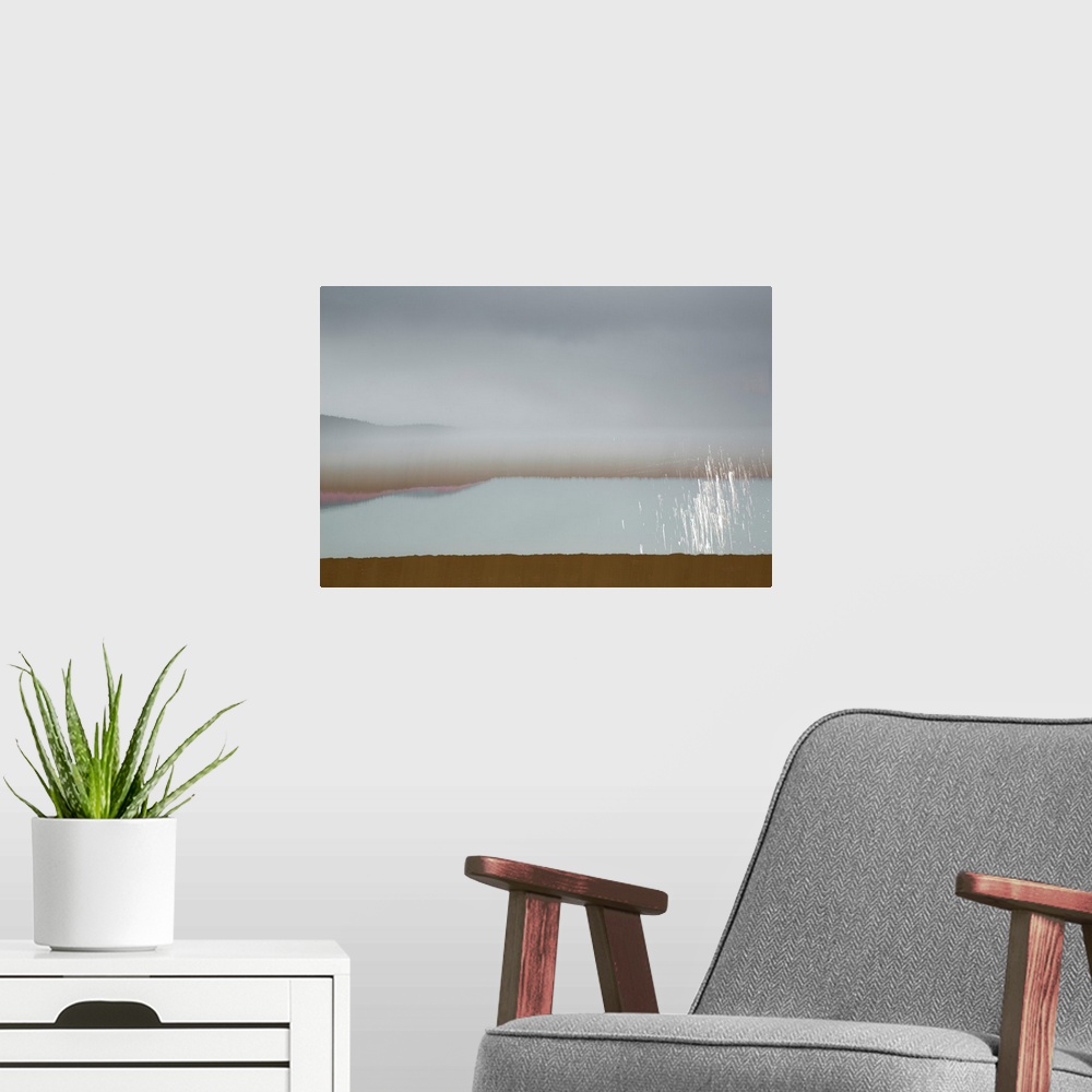 A modern room featuring Abstract image of a landscape with calming colors in shades of blue, brown, pink, and white.