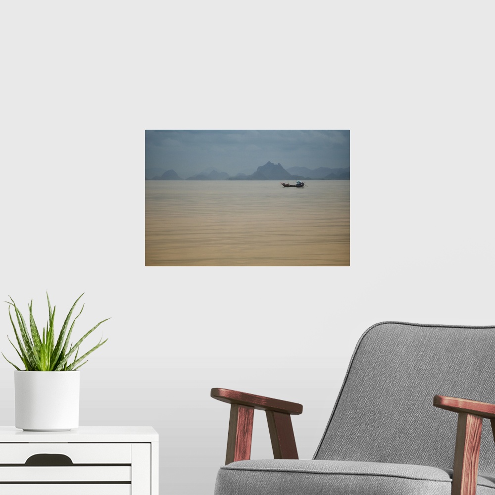A modern room featuring Single fishing boat in Thailand sea in the area of the Kho Phi Phi islands with mountains away, a...