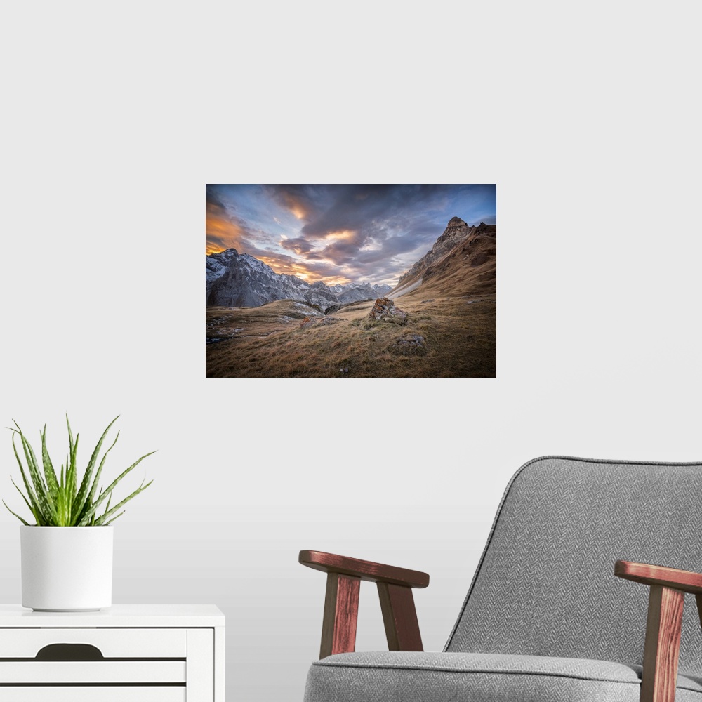 A modern room featuring Fine art photograph of an alpine landscape with colorful clouds overhead.