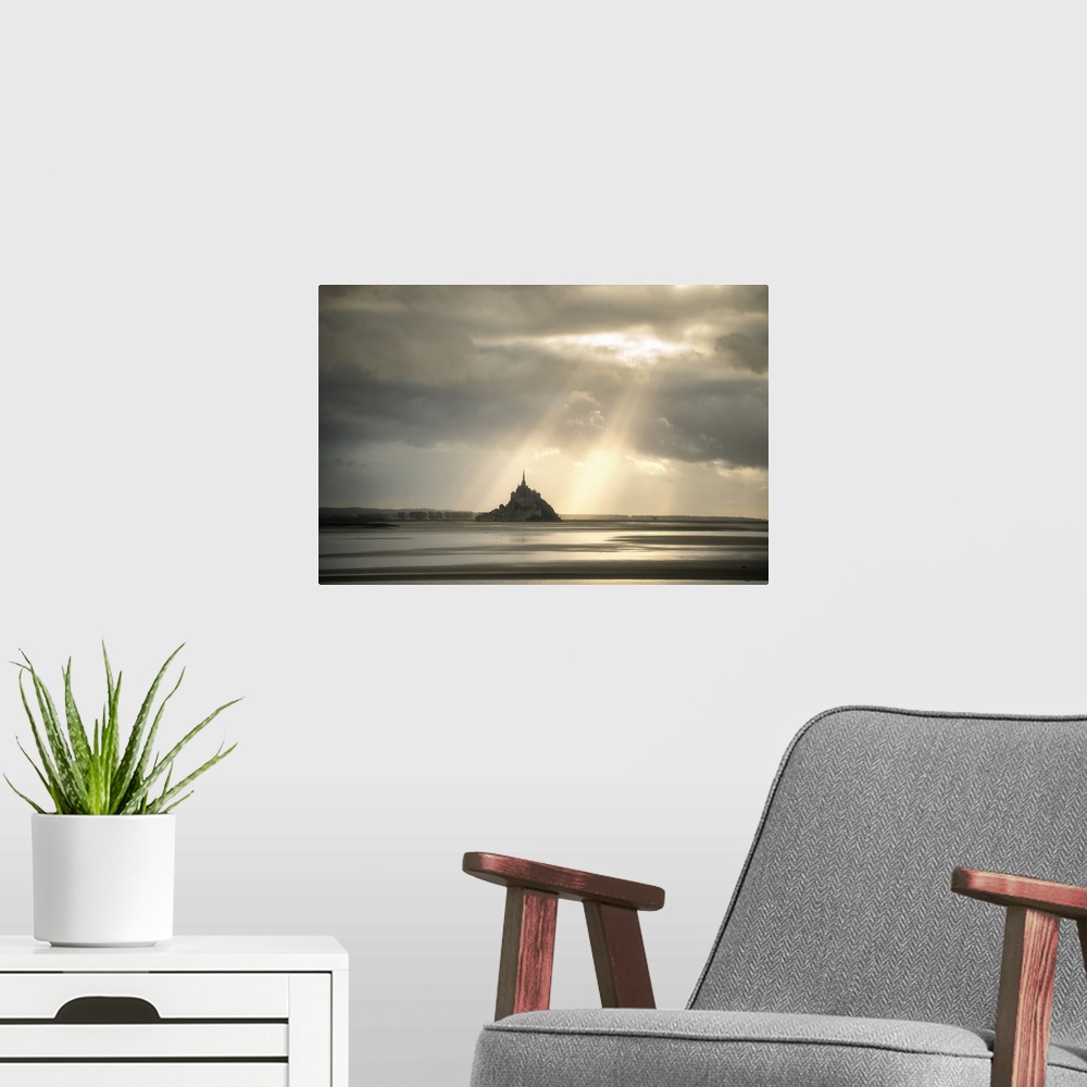 A modern room featuring Mont saint michel in normandy, France, before sunset! Sun rays passing throw the grey clouds givi...
