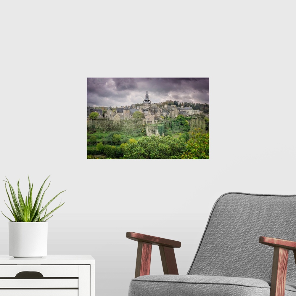 A modern room featuring A photograph of a historic village in France.