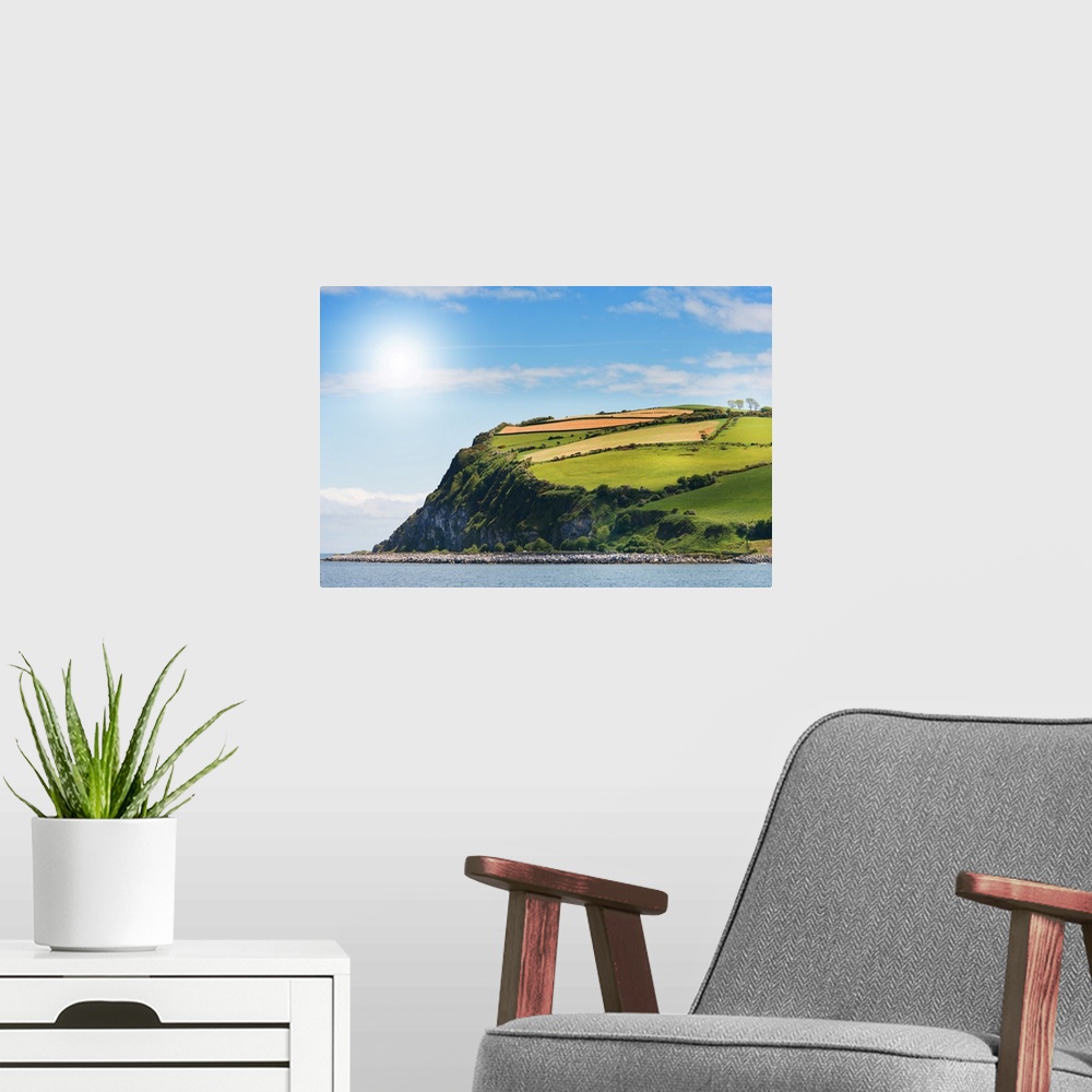 A modern room featuring A photograph of a coastal landscape.