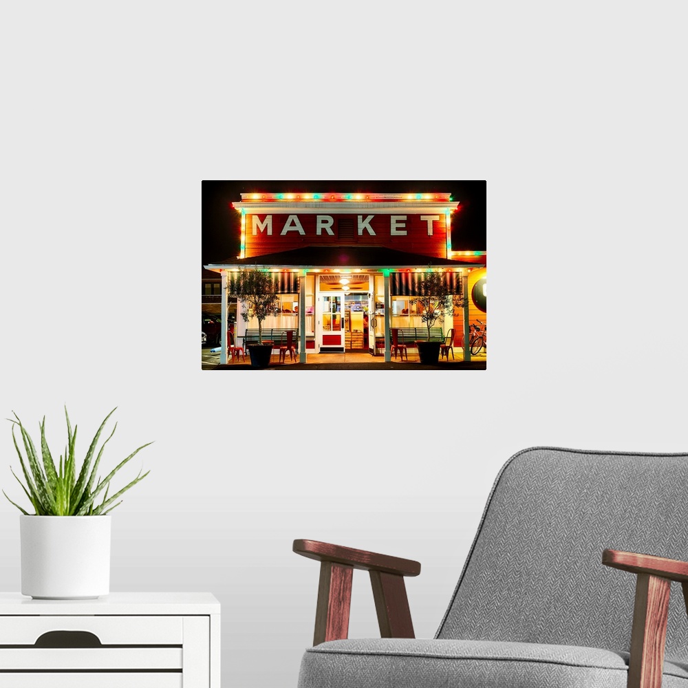 A modern room featuring Fine art photo of a market building in Napa Valley lit up at night.