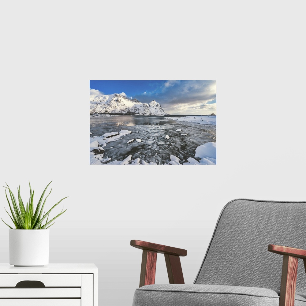 A modern room featuring A fjord surrounded by snow-capped mountains