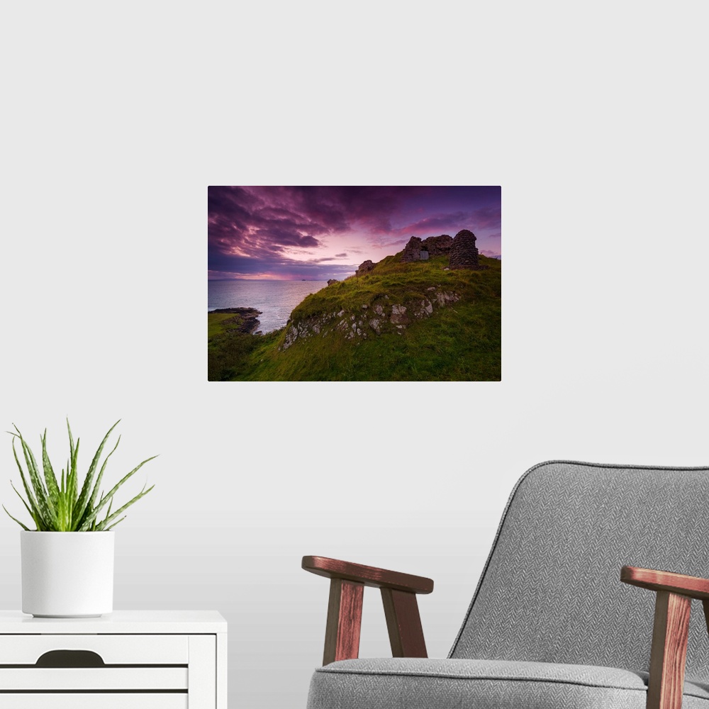 A modern room featuring Fine art photo of grassy hills overlooking the sea under a pastel sky at dusk.