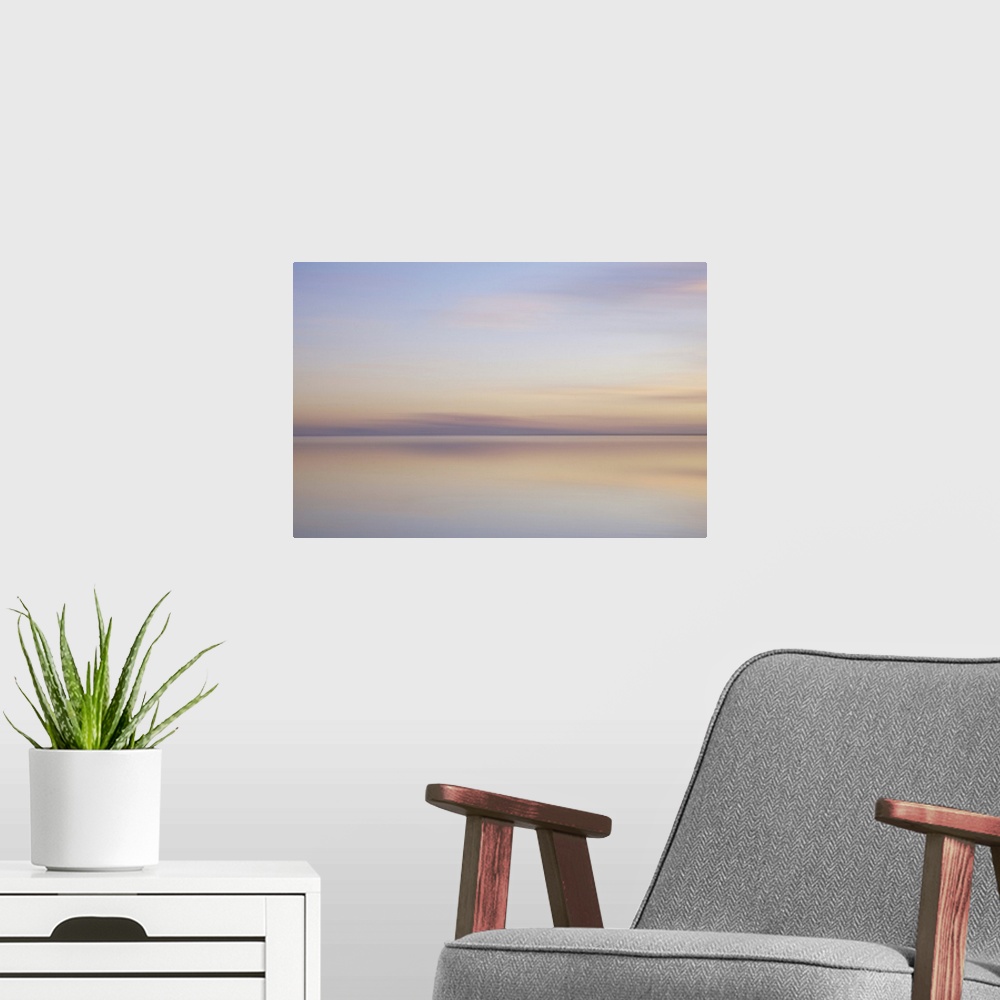A modern room featuring Artistically blurred photo. Sunlit clouds are flirting with their pastel colored reflection in th...