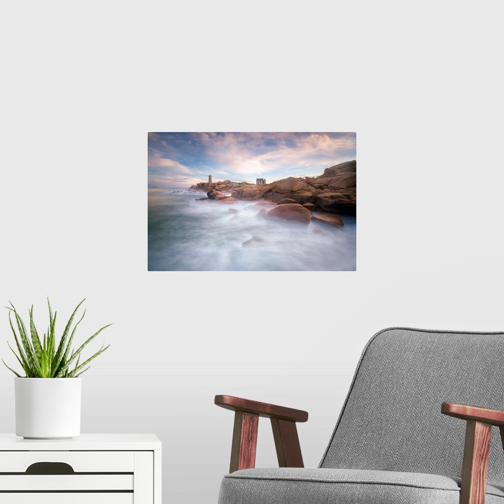 A modern room featuring Fine art photo of misty ocean waters at the rocky coast of France with a lighthouse in the distance.