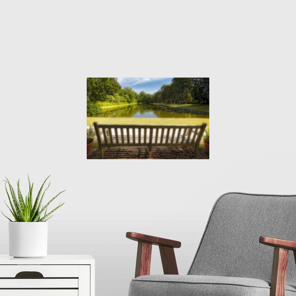 A modern room featuring A photograph of a bench looking out to a pond in South Carolina.