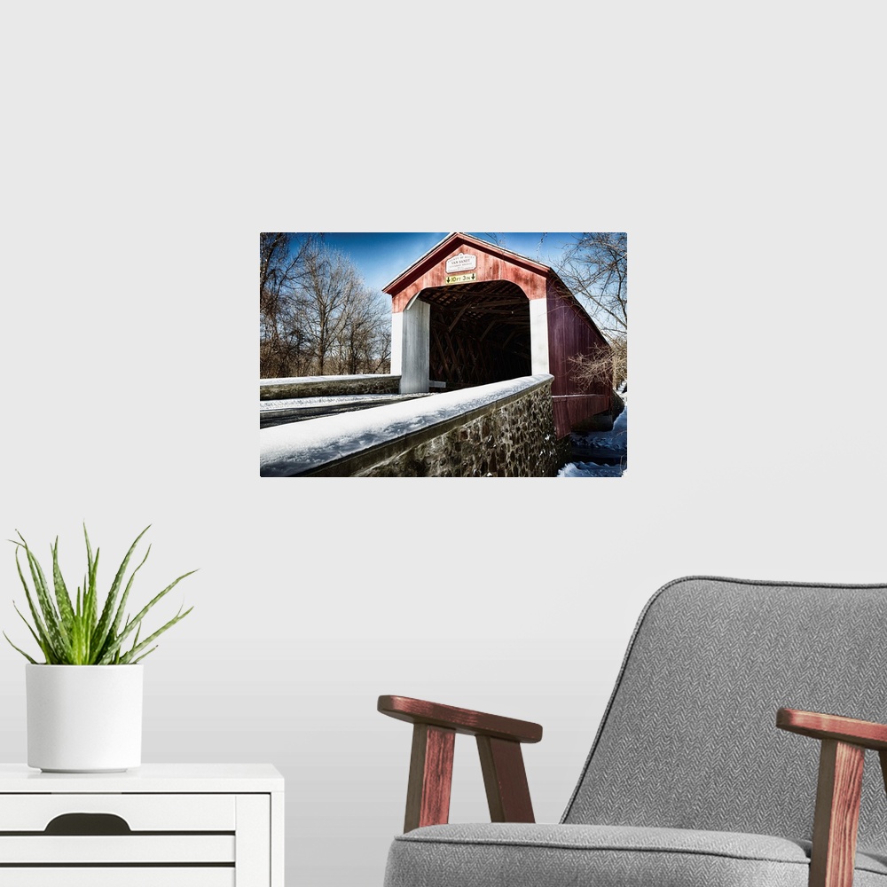 A modern room featuring Fine art photo of a covered bridge under a light snowfall.